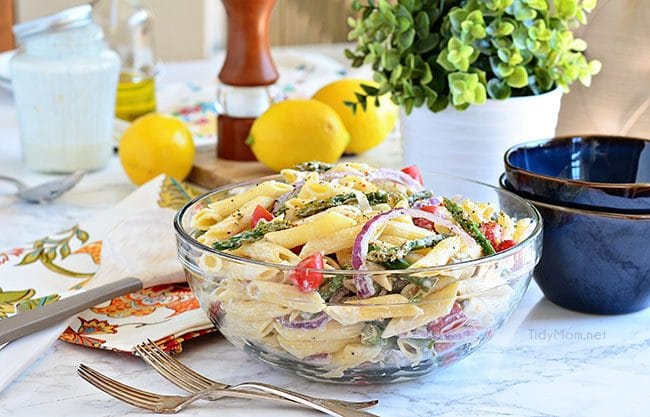 a glass bowl filled with pasta salad