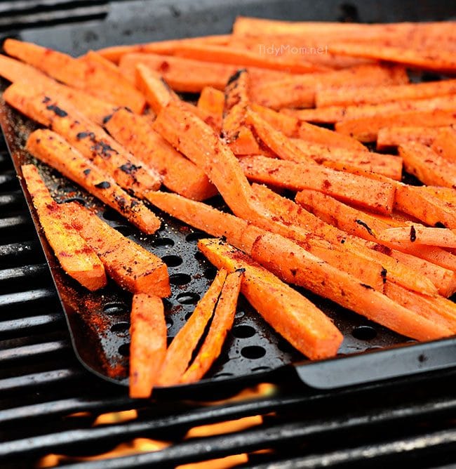 fresh carrots on a grill pan on a hot grill