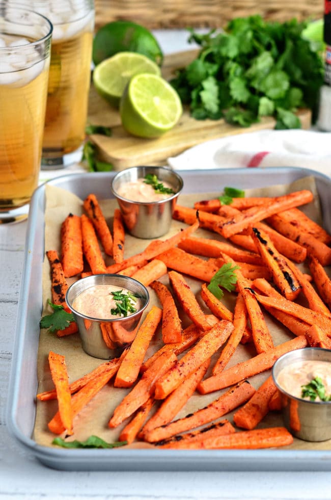 grilled carrots and dip with drinks and fresh limes in the background