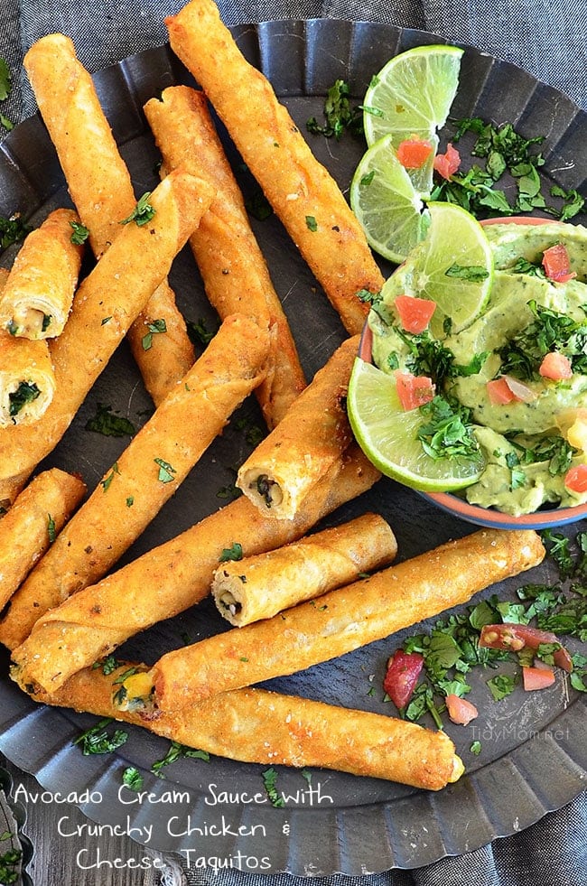 Creamy avocados, a little sour cream, and a whole lot of cilantro create a dreamy AVOCADO CREAM SAUCE that pairs perfectly with Extra Crunchy Chicken and Cheese Taquitos, for an after-school snack, party appetizer or meal. Recipe at TidyMom.net