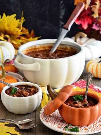 Fall table set with pumpkin bowls filled with chili