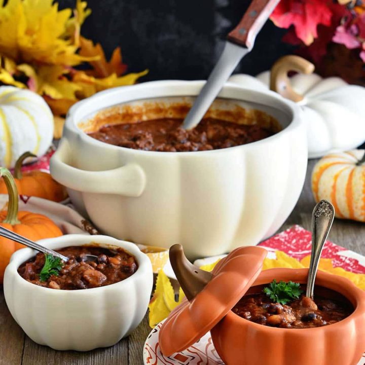 Fall table set with pumpkin bowls filled with chili