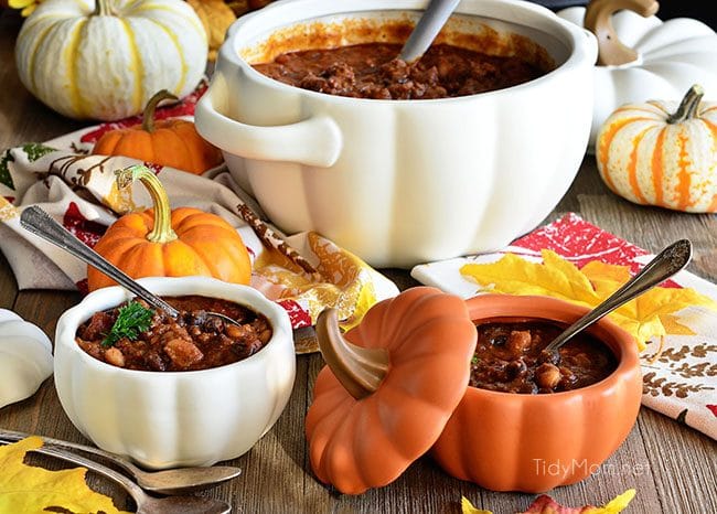 Pumpkin Chili with black and white chili beans in pumpkin bowls.