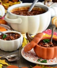 pumpkin chili served in lidded pumpkin bowls