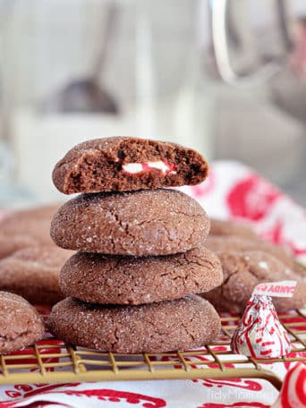 Super soft chocolate cookies hold a peppermint kiss in the center in these Peppermint Surprise Crinkle Cookies. Find the recipe at TidyMom.net