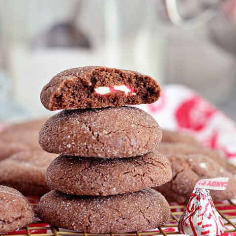 Super soft chocolate cookies hold a peppermint kiss in the center in these Peppermint Surprise Crinkle Cookies. Find the recipe at TidyMom.net