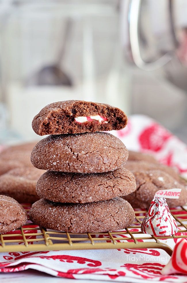 Super soft chocolate cookies hold a peppermint kiss in the center in these Peppermint Surprise Crinkle Cookies. Find the recipe at TidyMom.net