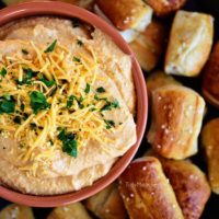 Pub-style Beer Cheese Dip with pretzel on tray
