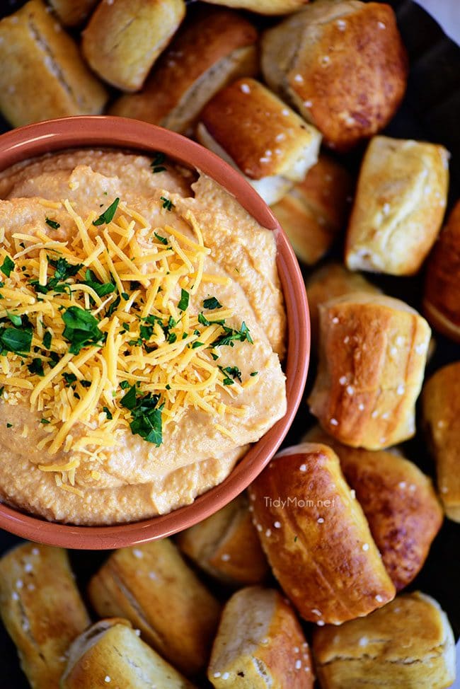 Pub-style Beer Cheese Dip with pretzel on tray