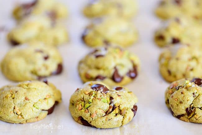 Pistachio cookies are sure to become a favorite! Perfect for St. Patricks Day, Easter, Christmas or any day. These deliciously soft pudding cookies are buttery and salty with dark chocolate chunks that pairs perfectly with chopped pistachios. I bet you can’t eat just one! Get the full printable recipe at TidyMom.net