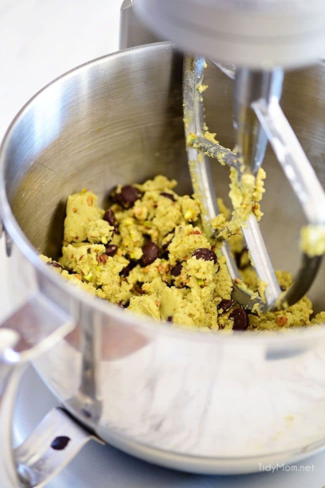 Pistachio cookies are sure to become a favorite! Perfect for St. Patricks Day, Easter, Christmas or any day. These deliciously soft pudding cookies are buttery and salty with dark chocolate chunks that pairs perfectly with chopped pistachios. I bet you can’t eat just one! Get the full printable recipe at TidyMom.net