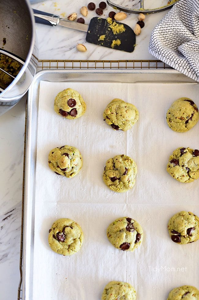 Pistachio cookies are sure to become a favorite! Perfect for St. Patricks Day, Easter, Christmas or any day. These deliciously soft pudding cookies are buttery and salty with dark chocolate chunks that pairs perfectly with chopped pistachios. I bet you can’t eat just one! Get the full printable recipe at TidyMom.net