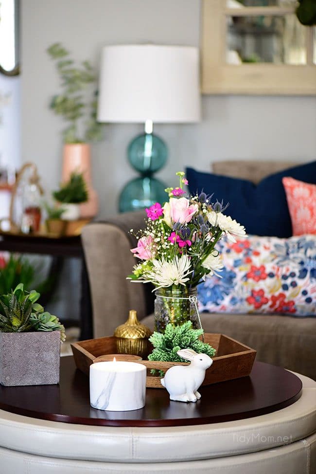 Transition to Spring Family Room Decor. Kick winter to the curb! Bring in the feel of freshness and spring to your home with lots of greenery, flowers and colorful pillows. See the full Spring Family Room Tour at TidyMom.net