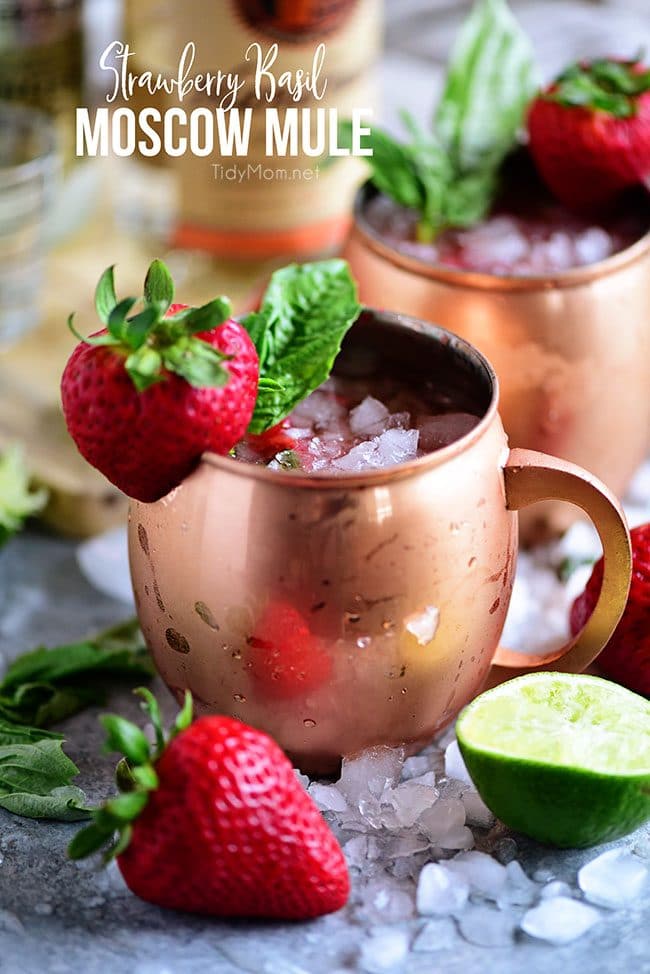 Strawberry Basil Moscow Mule is the perfect summer cocktail. Made like a traditional Moscow Mule with vodka, ginger beer and lime, with the addition of muddled fresh strawberries and basil. Print the recipe at TidyMom.net