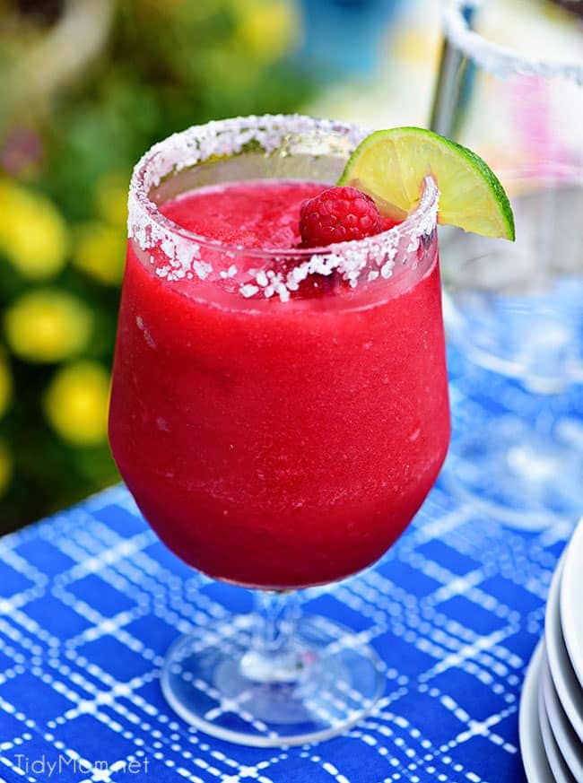 Frozen Rasberry Margarita is the perfect summer cocktail. Raspberry sorbet makes a refreshing twist on the traditional margarita, for a cool party sip! Get the full recipe at TidyMom.net