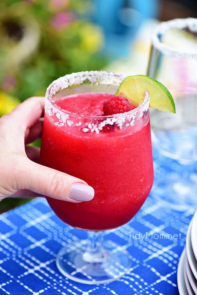 Frozen Raspberry Margarita is the perfect summer cocktail. Raspberry sorbet puts a refreshing twist on the traditional margarita, for a cool party sip! Get the full recipe at TidyMom.net - always a hit