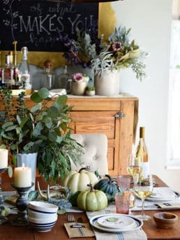Seasonal Simplicity — Blue and Green Fall Tablescape with simple eucalyptus and pumpkins fall centerpiece . Get all the details along with 20+ Fall Home Tours at TidyMom.net
