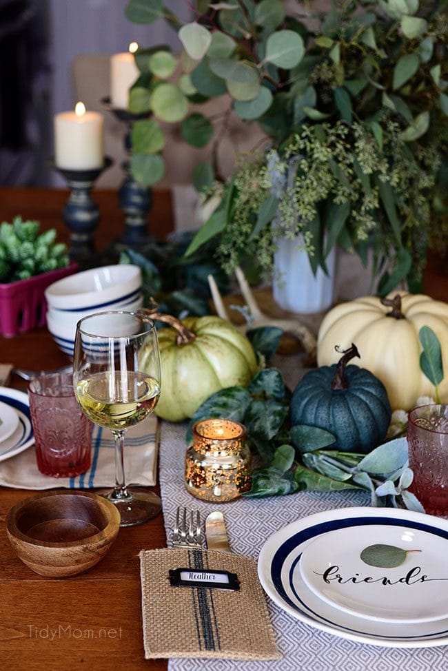 Seasonal Simplicity — Blue and Green Fall Tablescape with simple eucalyptus and pumpkins fall centerpiece . Get all the details along with 20+ Fall Home Tours at TidyMom.net