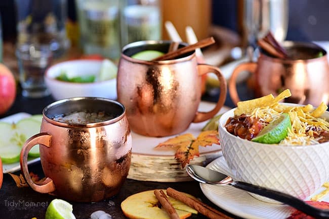 Caramel Apple Moscow Mule on copper mugs with a bowl of chili