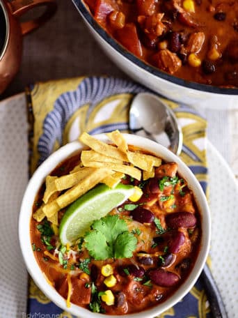 This flavorful Creamy Taco Chili is packed with lots of beans, chicken and other taco inspired ingredients. The perfect way to warm up on a chilly day! Printable recipe + video at TidyMom.net