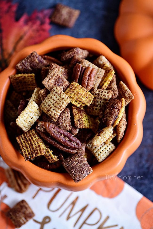 overhead shot of chex mix in a pumpkin bowl