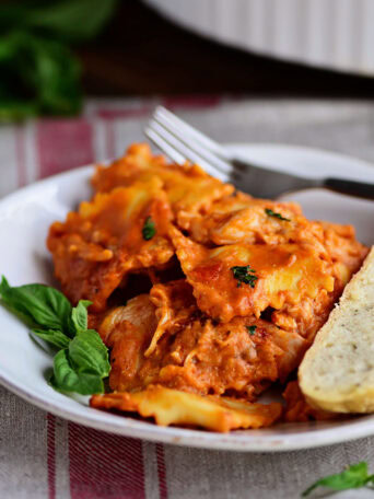 Cheesy Chicken Ravioli Bake on a plate with a fork