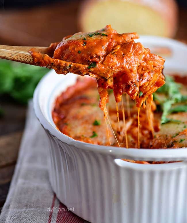 Cheesy Ravioli Bake with Chicken is easy to make and impossible to resist. Making it the perfect weeknight dish. Cheese ravioli, marinara sauce, chicken and lots of cheese, all layered and baked until bubbly and gooey! Print casserole recipe + view short recipe video at TidyMom.net