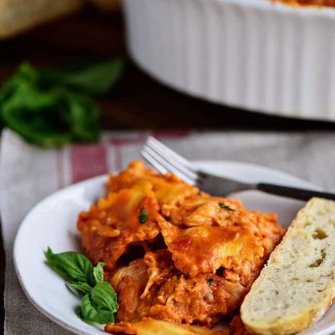 Cheesy Ravioli Bake Casserole with Chicken is easy to make and impossible to resist. Making it the perfect weeknight dish. Cheese ravioli, marinara sauce, chicken and lots of cheese, all layered and baked until bubbly and gooey! Print recipe + view short recipe video at TidyMom.net