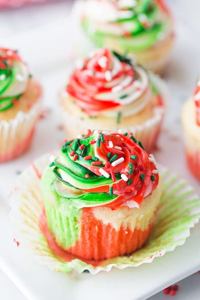 Very Merry Tricolor Christmas Cupcakes in red, green and white with a hint of peppermint! See how to make these fun colorful marble cupcakes and frosting at TidyMom.net