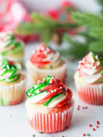 Very Merry Tricolor Christmas Cupcakes in red, green and white with a hint of peppermint! See how to make these fun colorful marble cupcakes and frosting at TidyMom.net