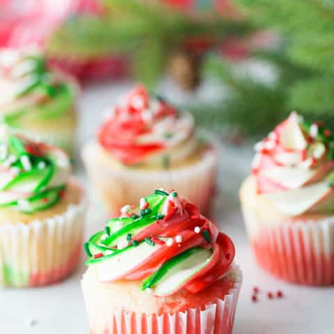 Very Merry Tricolor Christmas Cupcakes in red, green and white with a hint of peppermint! See how to make these fun colorful marble cupcakes and frosting at TidyMom.net