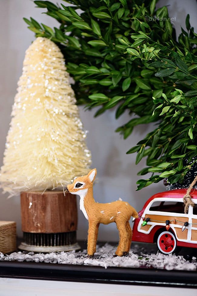 Bottlebrush Tree with doe and car. Merry and Bright Christmas Mantel Decor with rustic neutrals and a touch of red and green. Details at TidyMom.net