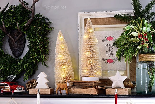 Lighted Bottle Brush Trees. Merry and Bright Christmas Mantel Decor with rustic neutrals and a touch of red and green. Details at TidyMom.net