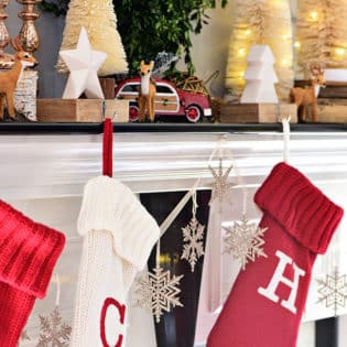 Red and white Christmas stockings. Merry and Bright Christmas Mantel Decor with rustic neutrals and a touch of red and green. Details at TidyMom.net