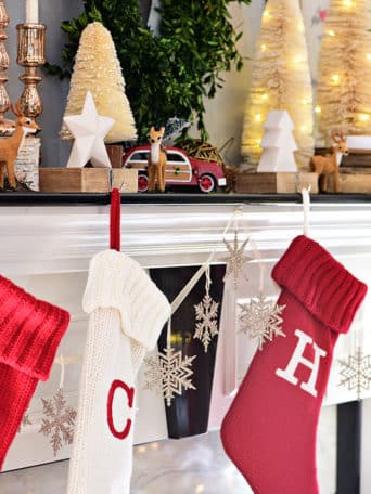 Red and white Christmas stockings. Merry and Bright Christmas Mantel Decor with rustic neutrals and a touch of red and green. Details at TidyMom.net