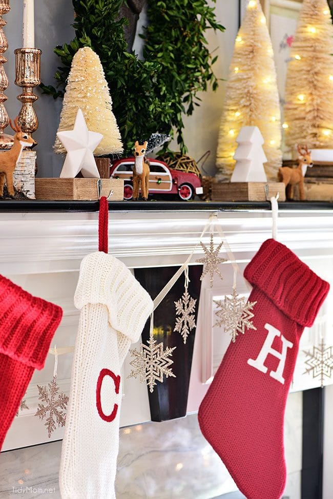 Red and white Christmas stockings. Merry and Bright Christmas Mantel Decor with rustic neutrals and a touch of red and green. Details at TidyMom.net