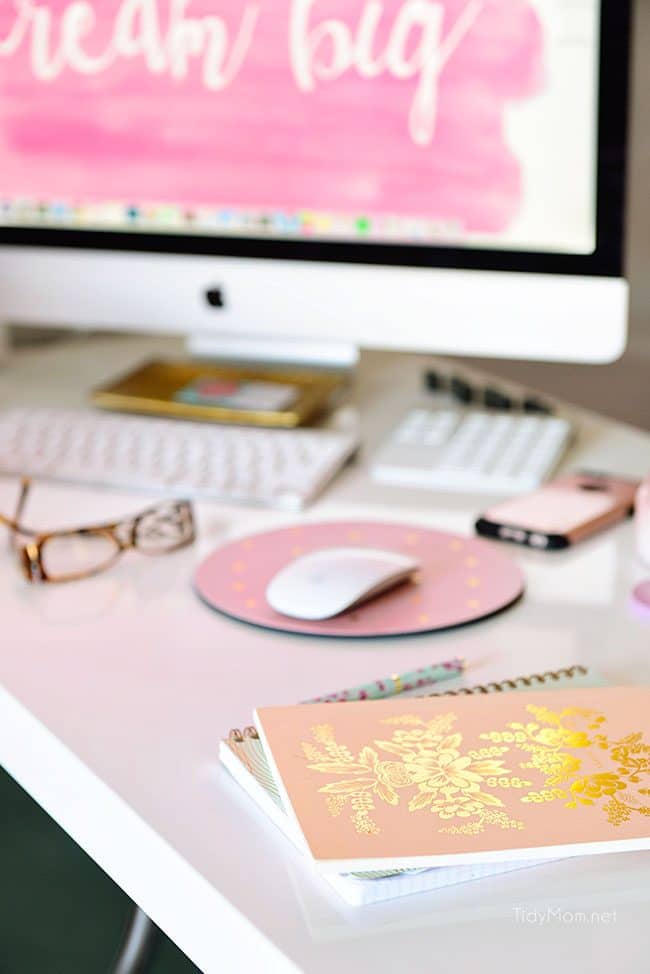 Decorating a shared office, with colorful industrial style. Her side is pink and gold, while his is black and neutrals. Check out the gold coffee cart!! Get all the details of this shared home office space at TidyMom.net