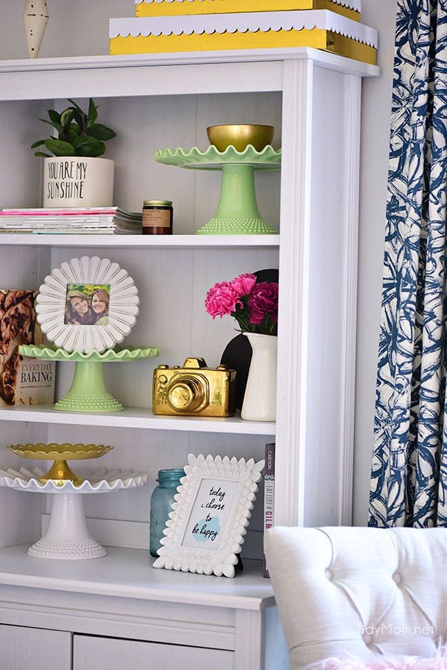 Decorating a shared office, with colorful industrial style. Her side is pink and gold, while his is black and neutrals. Check out the gold coffee cart!! Get all the details of this shared home office space at TidyMom.net