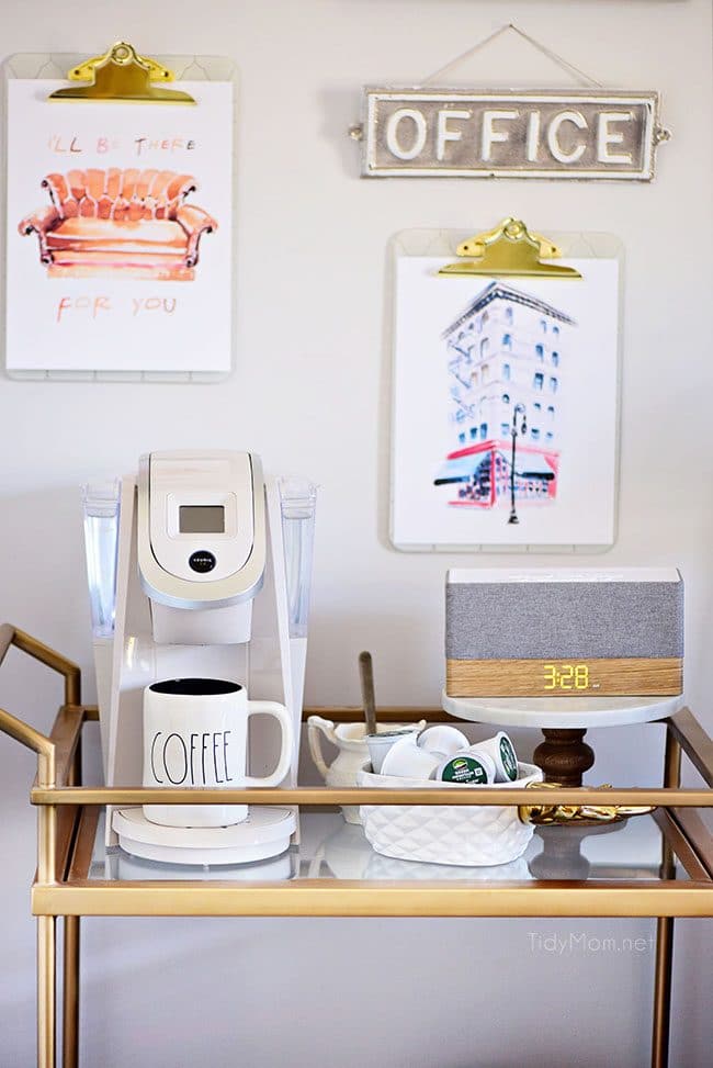 Decorating a shared office, with colorful industrial style. Her side is pink and gold, while his is black and neutrals. Check out the gold coffee cart!! Get all the details of this shared home office space at TidyMom.net