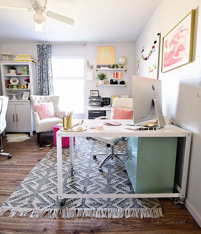 Decorating a shared office, with colorful industrial style. Her side is pink and gold, while his is black and neutrals. Check out the gold coffee cart!! Get all the details of this shared home office space at TidyMom.net