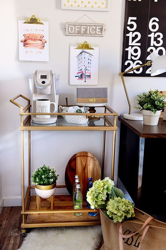Decorating a shared office, with colorful industrial style. Her side is pink and gold, while his is black and neutrals. Check out the gold coffee cart!! Get all the details of this shared home office space at TidyMom.net