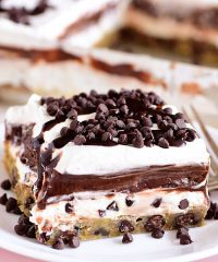 a big slice ofChocolate Chip Cookie Layered Delight on pink plate