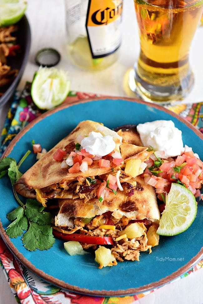 Pineapple chicken Quesadillas are stuffed with sweet peppers, caramelized onion, pineapple and lots of melty cheese.