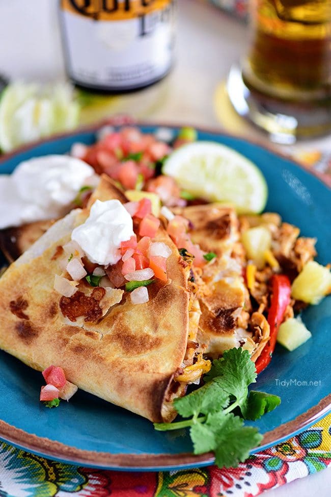 Pineapple chicken Quesadillas are stuffed with sweet peppers, caramelized onion, pineapple and lots of melty cheese.