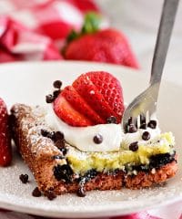 This Strawberry Gooey Butter Cake is a simply delicious dessert bar with an unexpected Oreo cookie layer. If you are a fan of strawberries, you will love this easy dessert recipe. Print the full recipe at TidyMom.net