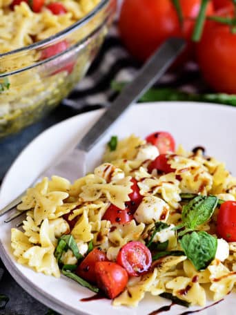 Caprese Pasta Salad is fresh, easy and a perfectly simple for summer potlucks and BBQs. It has all the flavors of a traditional Caprese salad in pasta form!