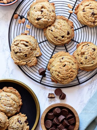 Peanut Butter Blowout Cookies are loaded with peanut butter, chocolate chips, peanut butter cups and honey roasted peanuts. Print the full recipe at TidyMom.net