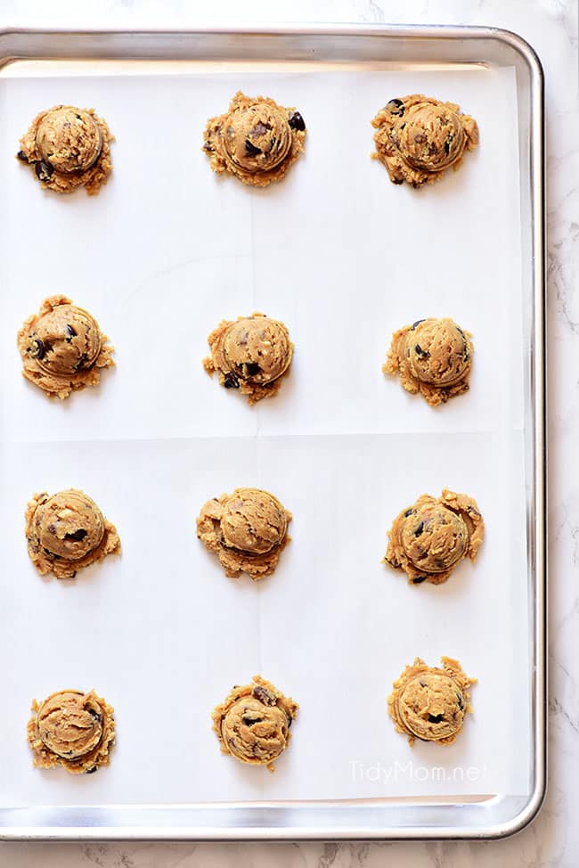 Scooped Peanut Butter Blowout Cookie dough balls on a baking sheet