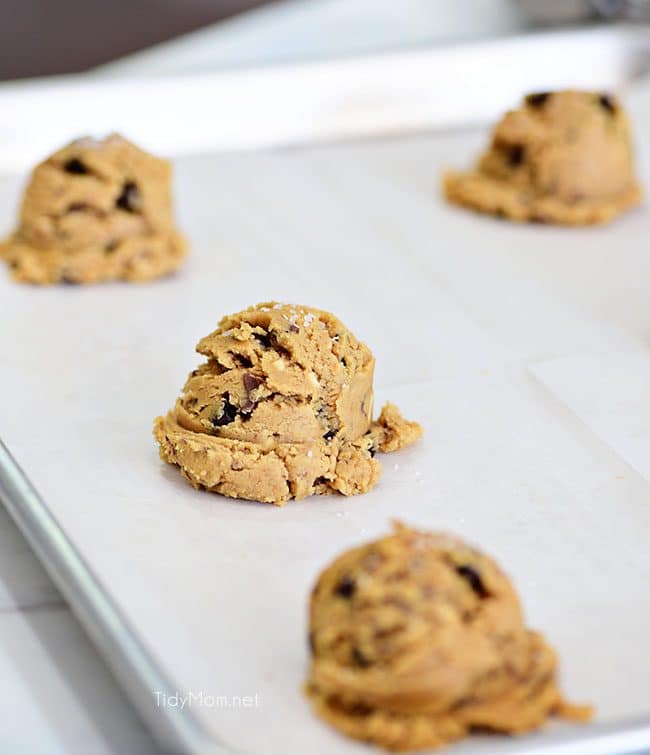 Peanut Butter Blowout Cookies are loaded with peanut butter, chocolate chips, peanut butter cups and honey roasted peanuts. Print the full recipe at TidyMom.net