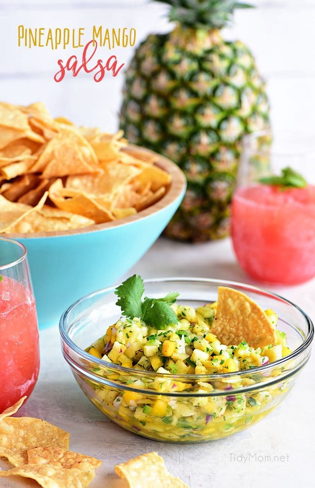 A tropical fruit salsa with a kick of jalapeno that will knock your socks off! This Pineapple Mango Salsa recipe is the perfect addition to chicken, pork, fish, tacos or tortilla chips. Print full recipe at TidyMom.net #salsa 